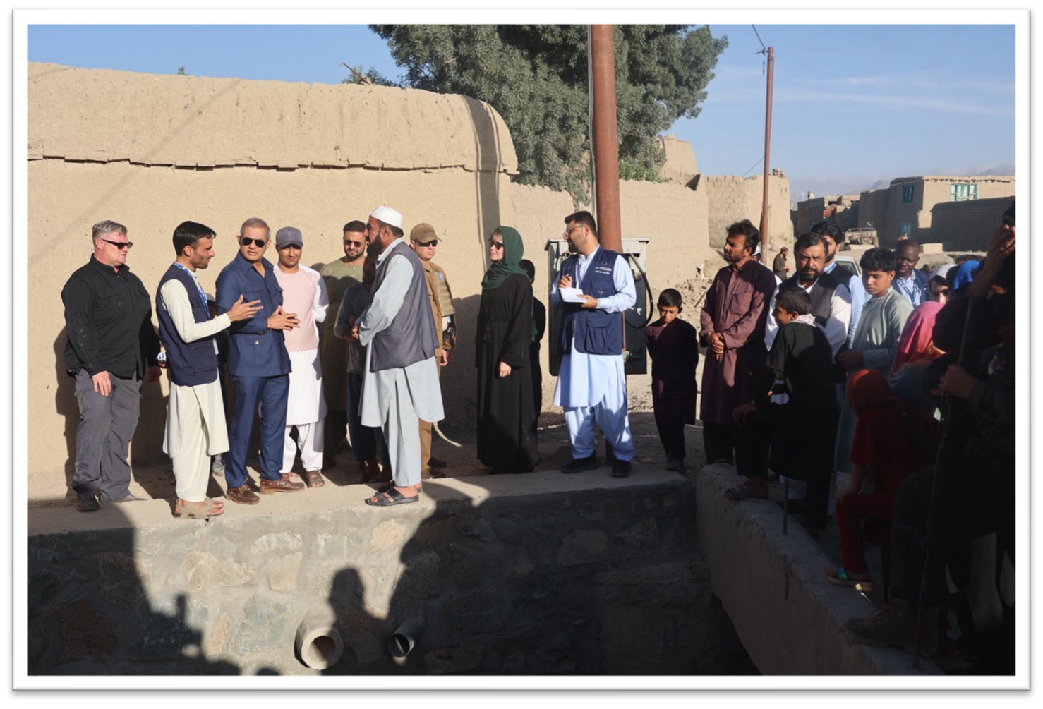 The Resident Coordinator visiting a flood protection wall which was constructed with support from UN-Habitat under the STFA 