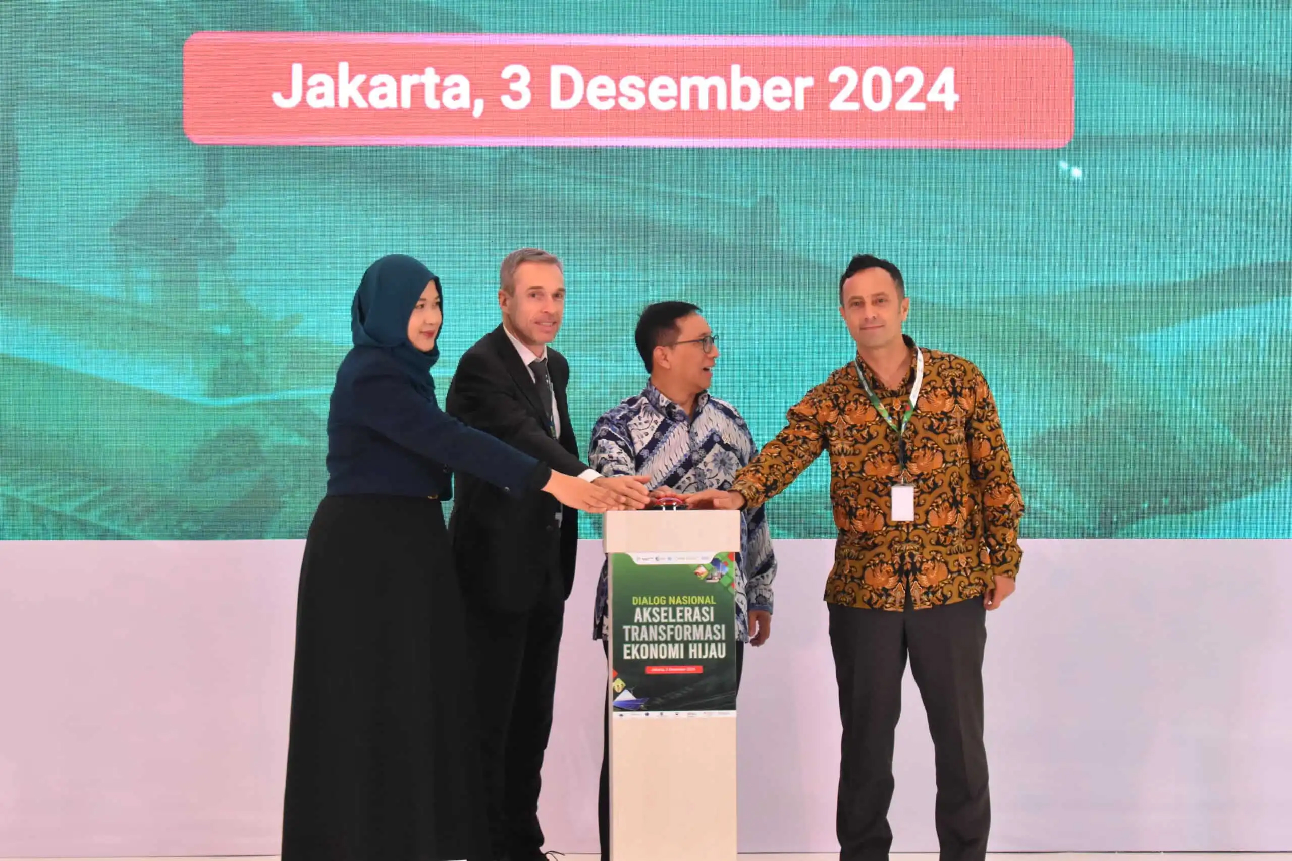 Page news image Jakarta conference group at podium hands symbolically pushing a button 