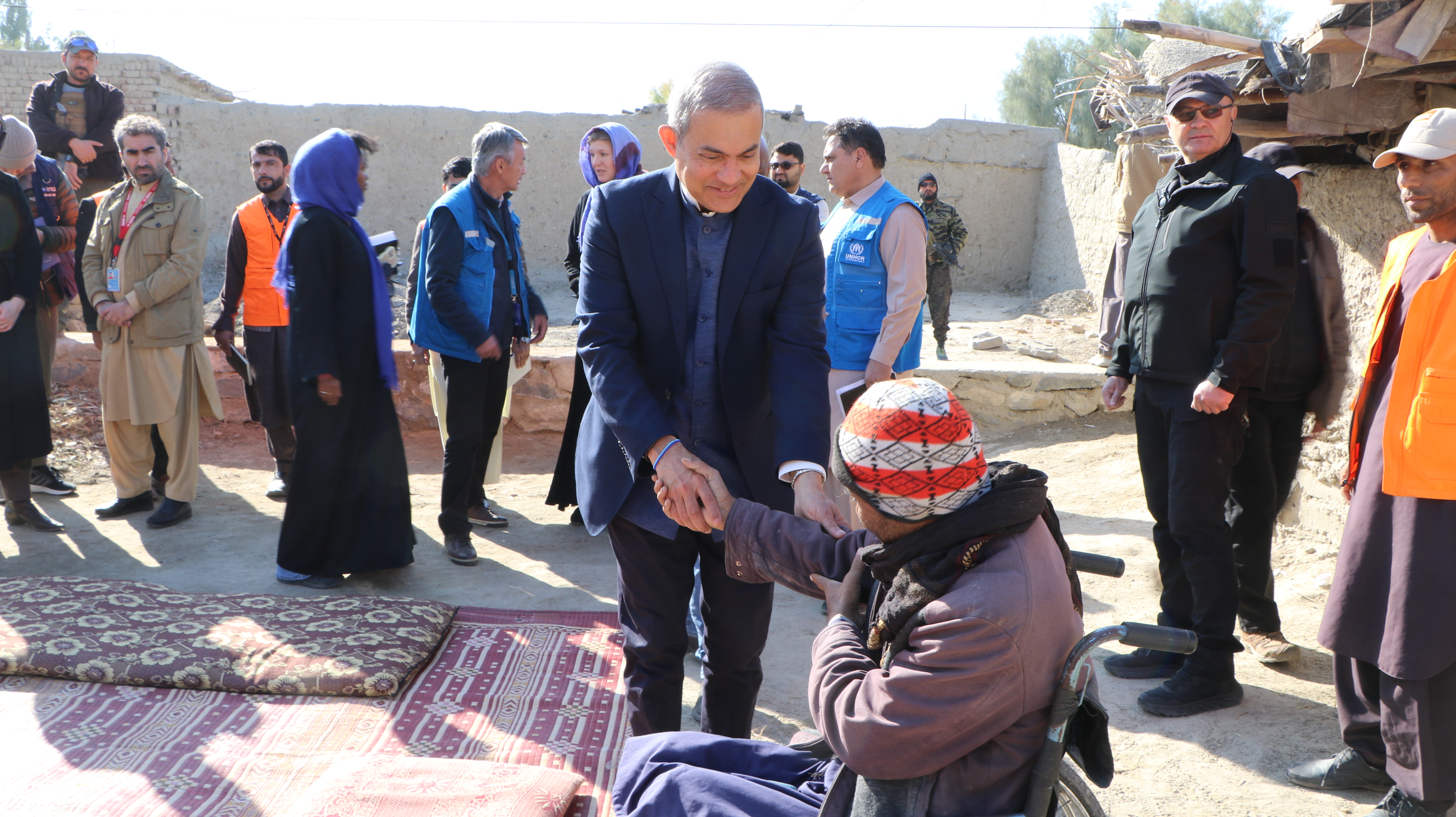 Visit to the Khogyani community resource centers. Shaking hand with a person in a wheelchair.