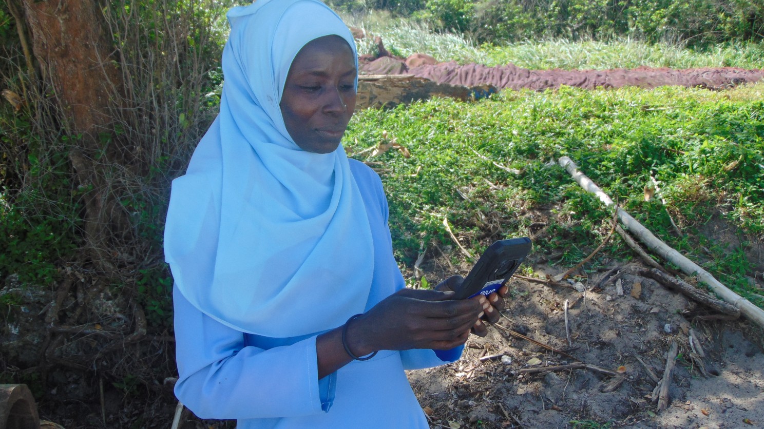 Ranger Asha Juma using the EarthRanger digital tool to track the daily patrols.