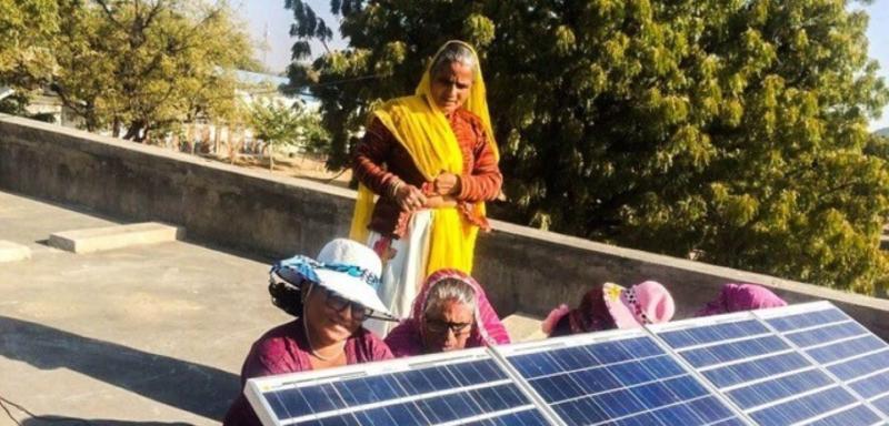 Marta learning to assemble the solar power system equipment with other Barefoot scholars.