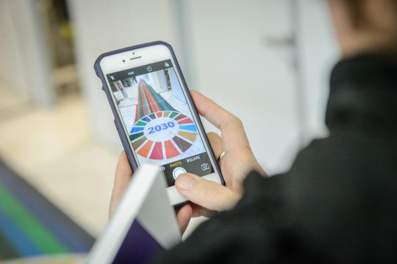 SDG wheel and graphic observed through a phone screen