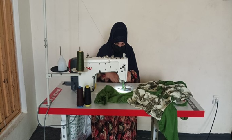 Sahar sewing a cloth in her home-based tailoring business in Logar Province