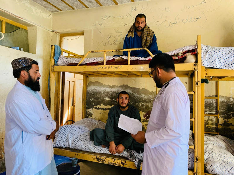 A doctor talks to Mohammad during his rehabilitation at a drug treatment center in Khost Province